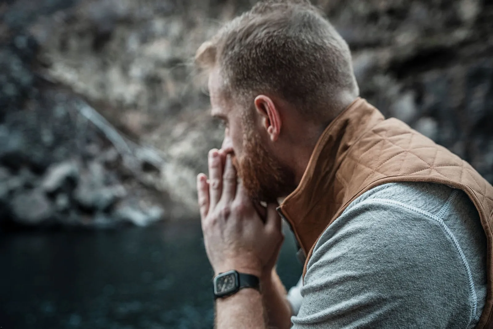 Roger by the water, hands pressed together