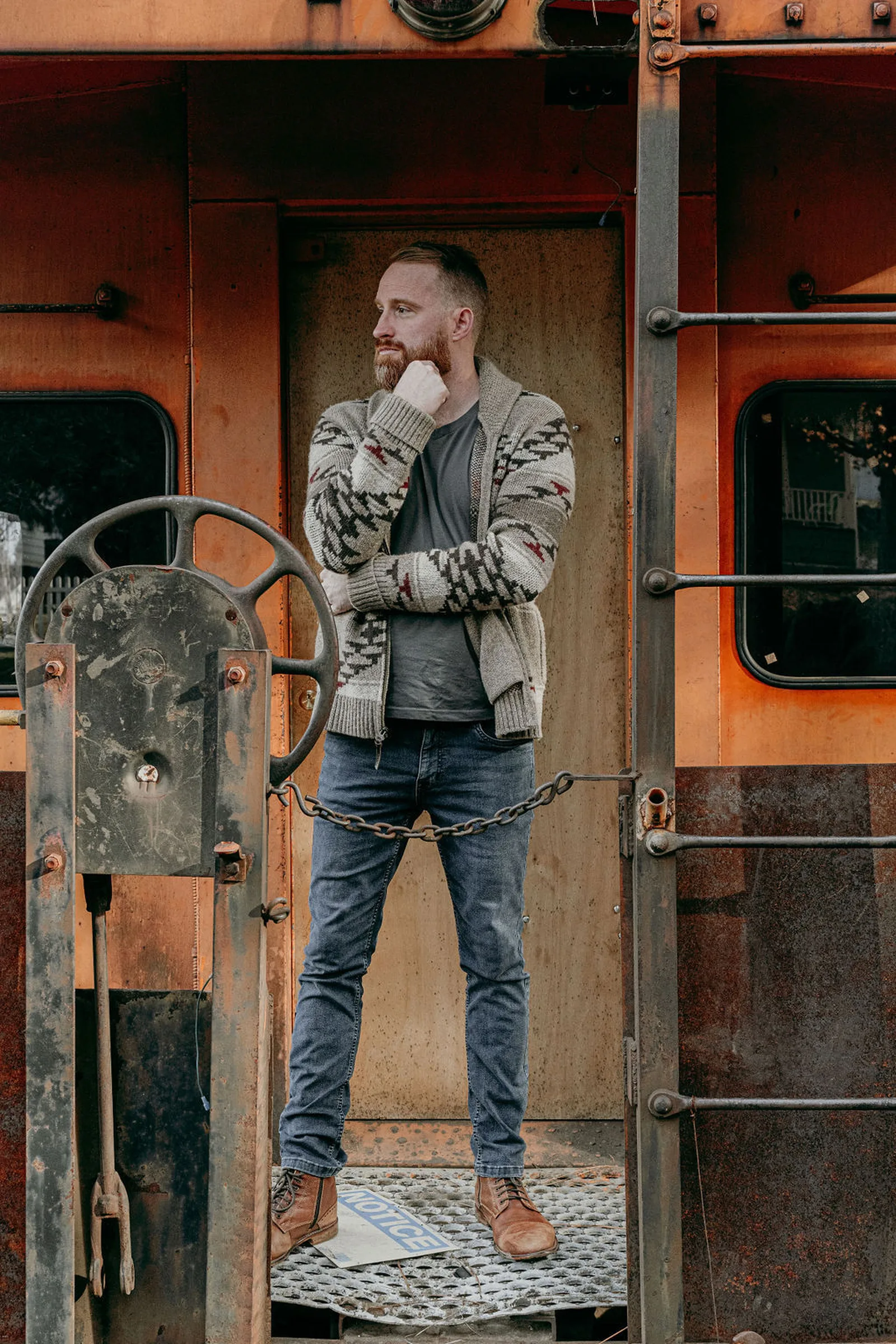 Roger standing on the platform of an old caboose