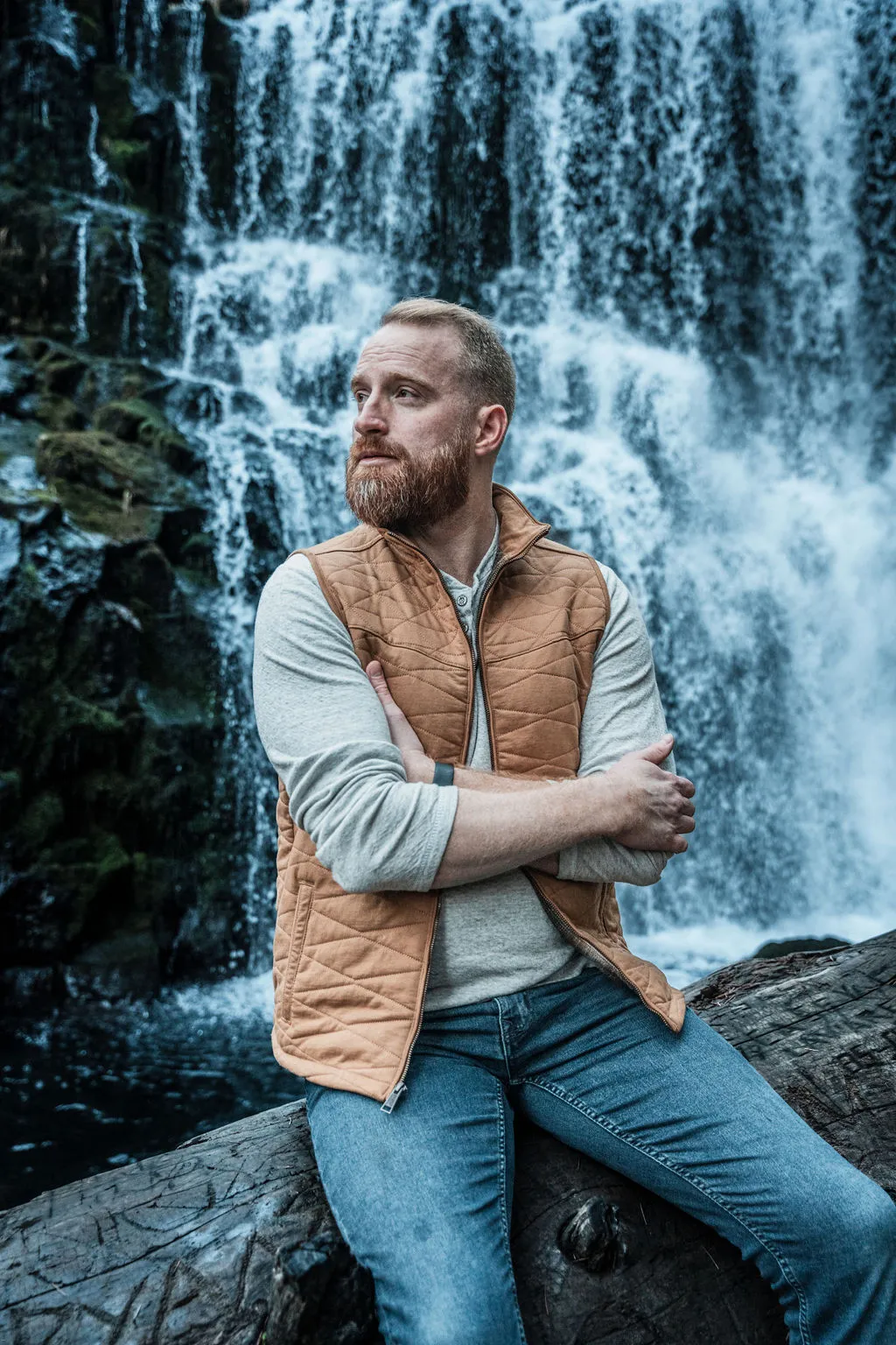 Roger seated by a waterfall